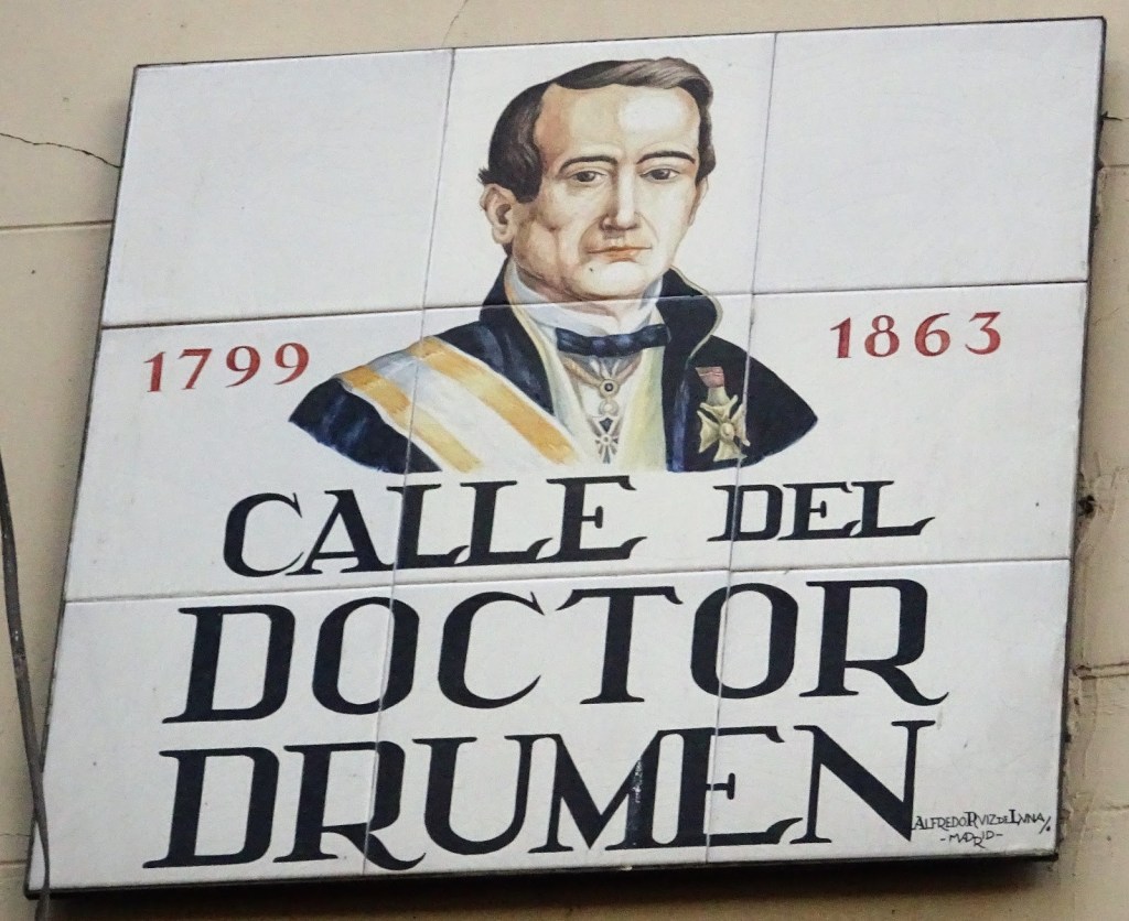 Placa del carrer de Madrid dedicat al Dr. Joan Drumen Millet. 
La imatge està basada en un dibuix de Real Academia Nacional de Medicina