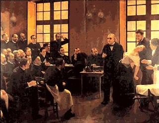 Una lliçó clínica a la Salpêtrière (1887), d'André Brouillet. De la Tourette és el primer de la primera fila, i duu davantal blanc